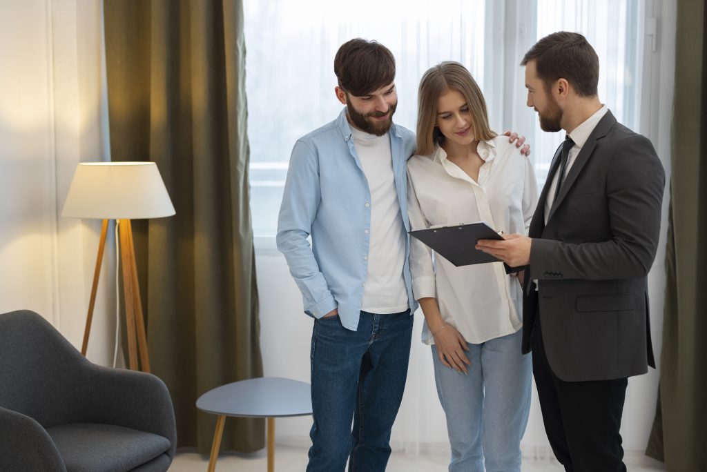 male-real-estate-agent-doing-business-showing-house-potential-buying-couple